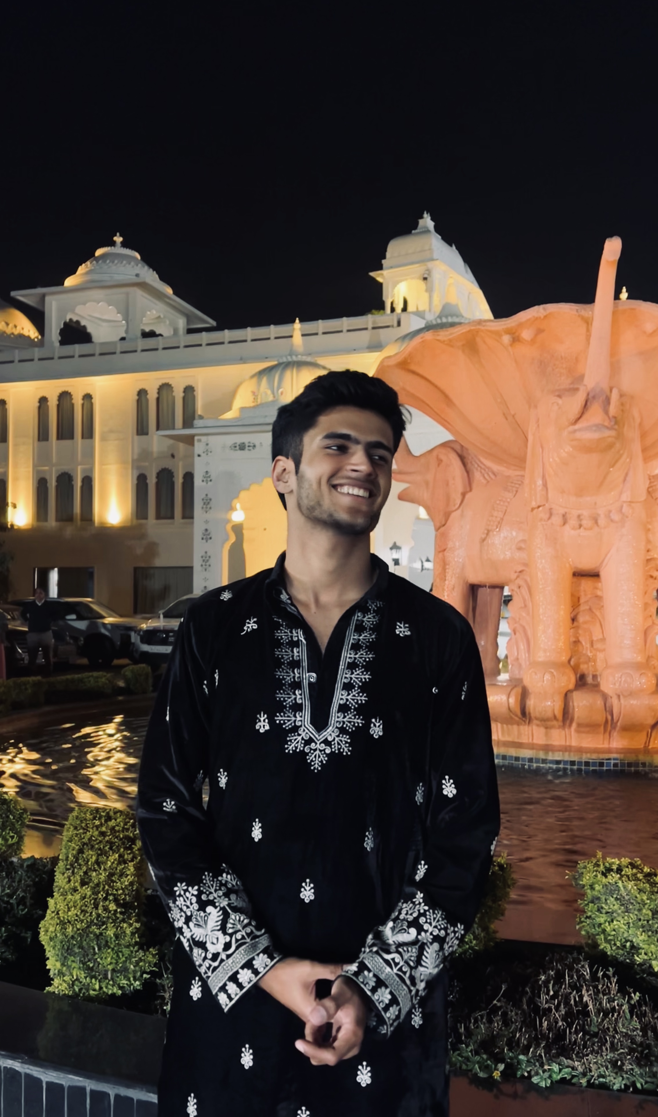 Atharva Sharma in black embroidered velvet kurta at illuminated fountain
