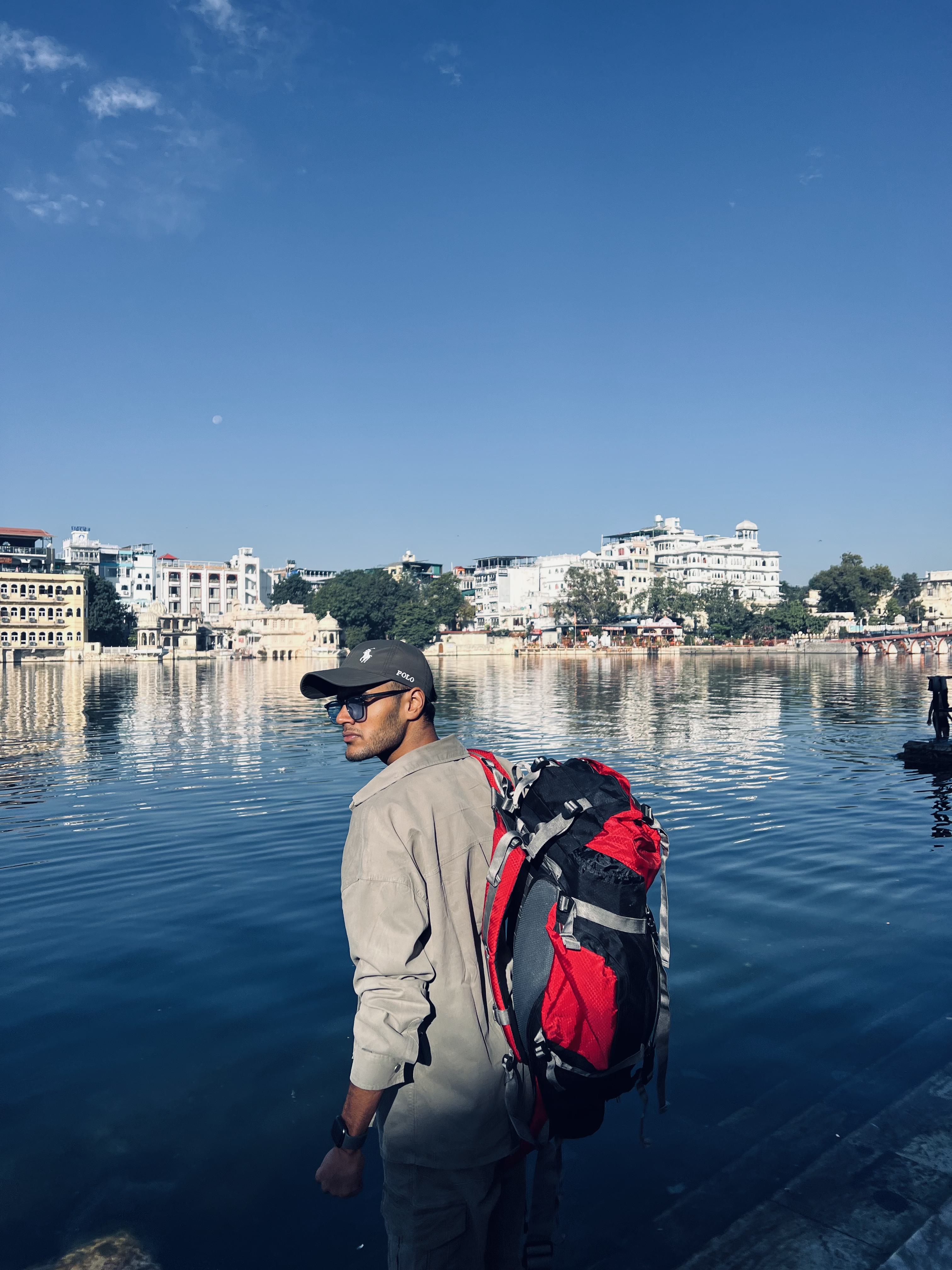 Atharva Sharma backpack overlooking Udaipur lake ghats